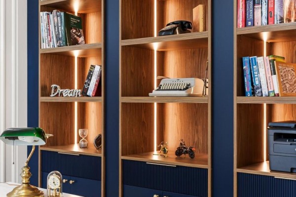 Close-up of wooden bookshelves with decorative items and integrated lighting. - 8 Canary Crescent, Toronto