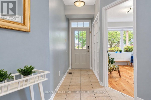 Interior hallway with light blue walls, tiled floor, and entryway. - 8 Colindale Avenue, Ottawa