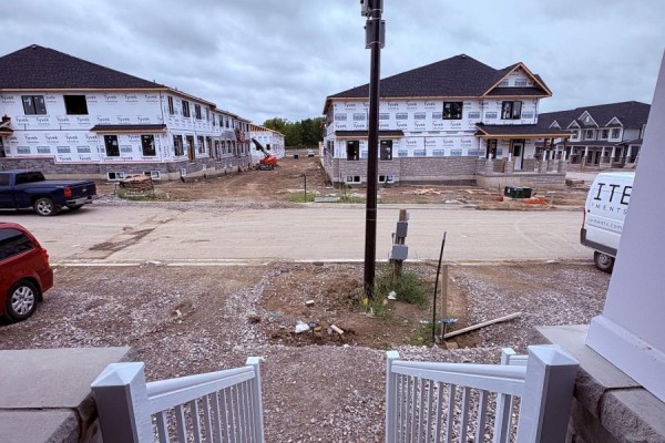Townhouse construction site with multiple buildings and surrounding debris. - 8 Elite Crescent, Haldimand