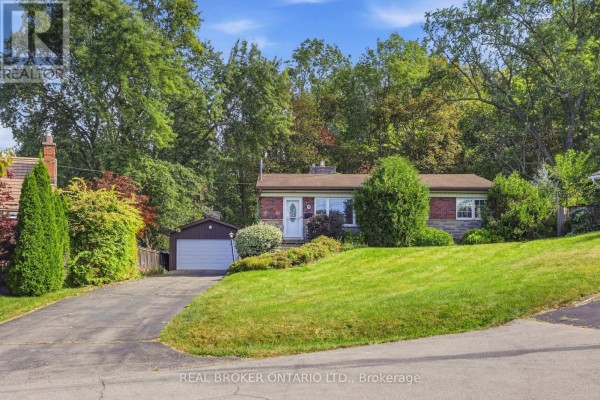 Front exterior of a red brick bungalow with a detached garage and a sloping green lawn. - 8 Hill Place, Hamilton