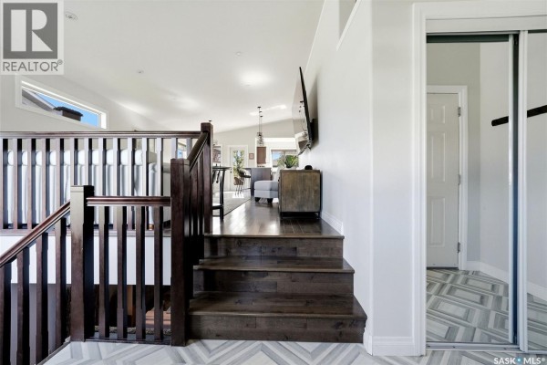 View down an interior staircase with dark wood railings and treads, leading to the main floor. - 8 Lott Road E, White City