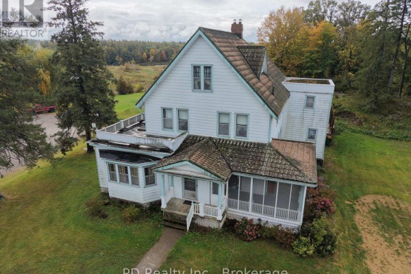 Aerial view of the white house with a screened-in porch and a flat roof balcony. - 8 Private (deloro) Road, Marmora And Lake