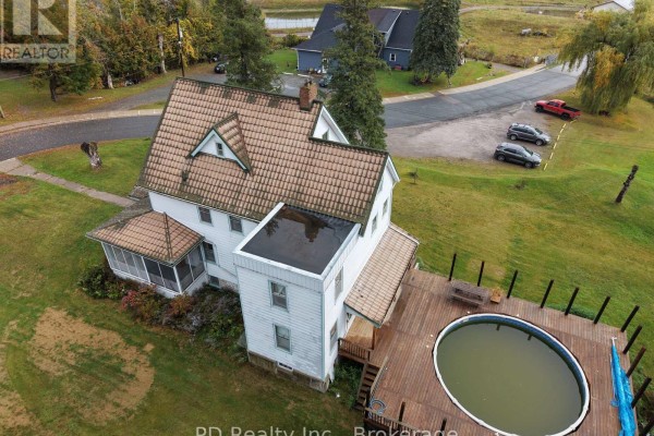 Aerial view of the rear of the house showing a wooden deck with an oval pool. - 8 Private (deloro) Road, Marmora And Lake