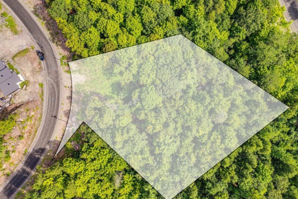 Overhead drone view of a vacant lot with a paved road and surrounding trees. - 8 Rue Tex-lecor, Cantley