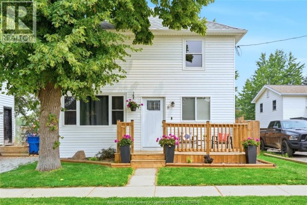 Exterior view of a white two-story house with a wooden deck and driveway. - 8 St. Clair Street, Tilbury