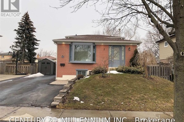 Front exterior view of a detached house with a snow-covered lawn and a detached garage. - 8 Sutherland Avenue, Brampton