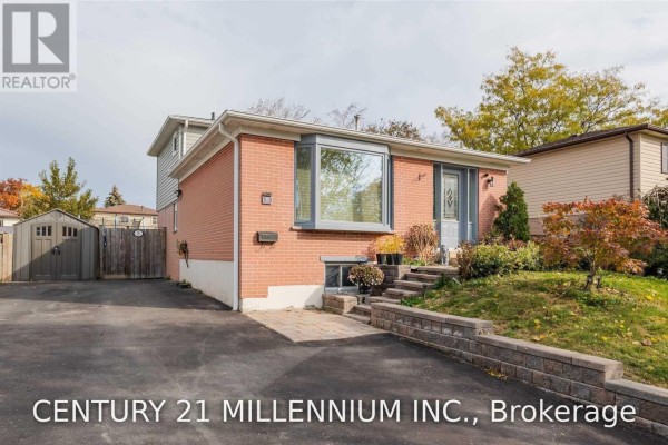 View of the front of a brick house with a bay window and landscaped garden. - 8 Sutherland Avenue, Brampton