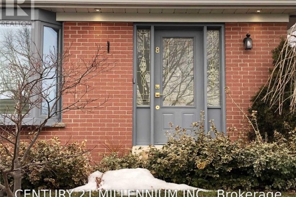 Close-up view of the front door with glass panels and brick exterior. - 8 Sutherland Avenue, Brampton