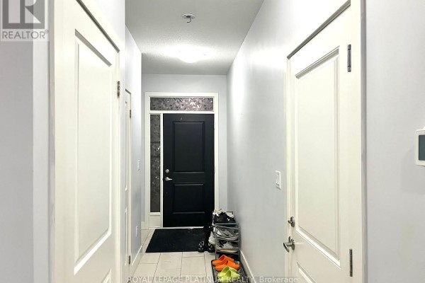 Interior view of a hallway with white doors, grey walls, and a black front door. - 80 - 1375 Whetherfield Street, London North
