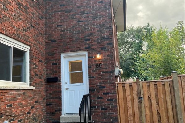 Exterior front door with house number 80 and a black mailbox on a brick wall. - 80 Delawana Drive, Hamilton