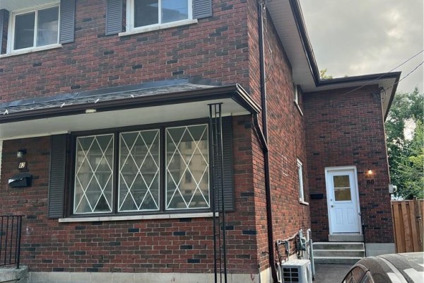 Exterior view of a red brick house with multiple windows and house number 80. - 80 Delawana Drive, Hamilton