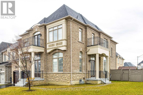 Detailed view of the house's brick facade, showing balconies and windows. - 80 Royal West Drive, Brampton