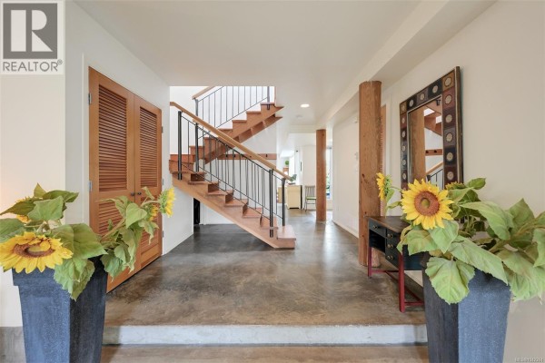 Interior entryway with wooden staircase and concrete floors. - 80 San Jose Ave, Victoria