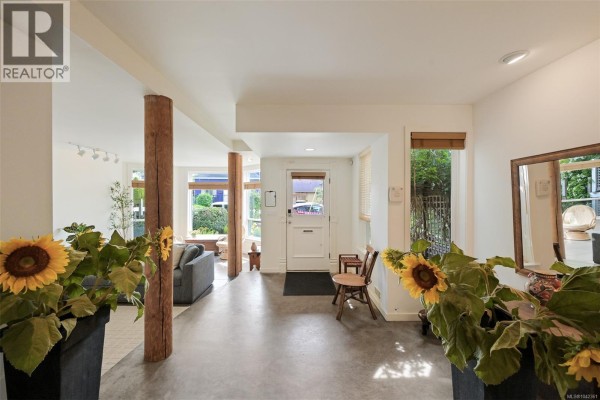 Spacious interior foyer with wood beams and decorative sunflowers. - 80 San Jose Ave, Victoria