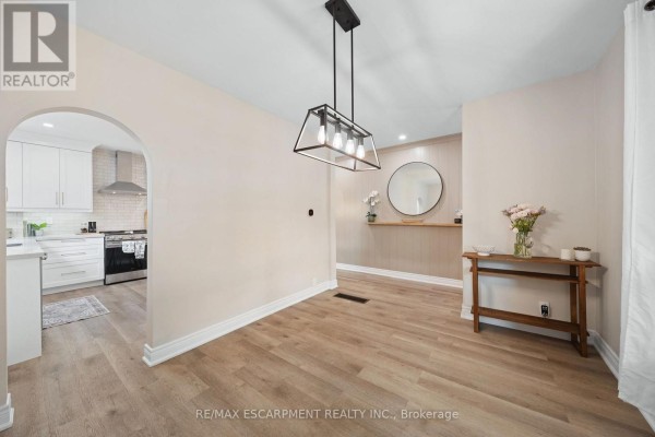 Modern hallway with archway to kitchen and console table - 80 Sarah Street Brant