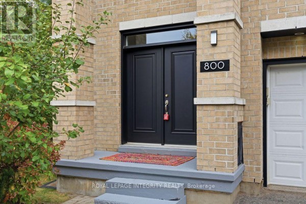 Close-up of the front entrance with double black doors, a concrete porch, and address number 800. - 800 Petra Private, Ottawa