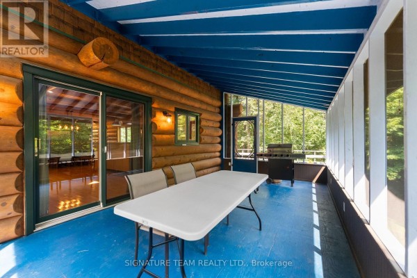 Aerial view of log home nestled in a forested area - 800 Woito Station Road, Laurentian Valley