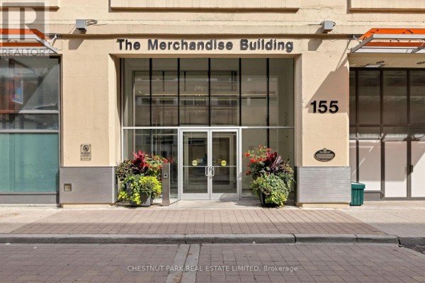 Main entrance of The Merchandise Building at 155 Dalhousie Street, with glass doors and planters. - 801 - 155 Dalhousie Street, Toronto