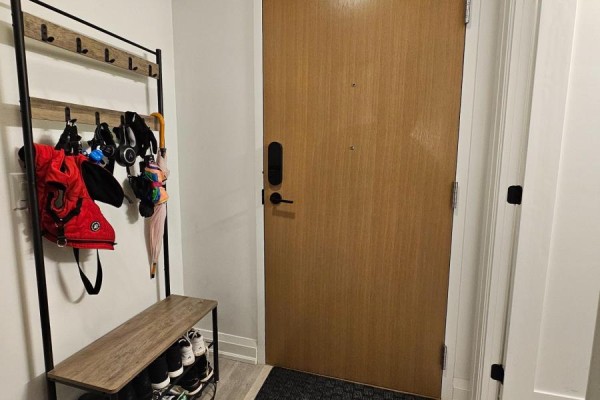 Entryway with coat rack, bench, and shoe storage near the front door - 801 - 2369 Danforth Avenue, Toronto