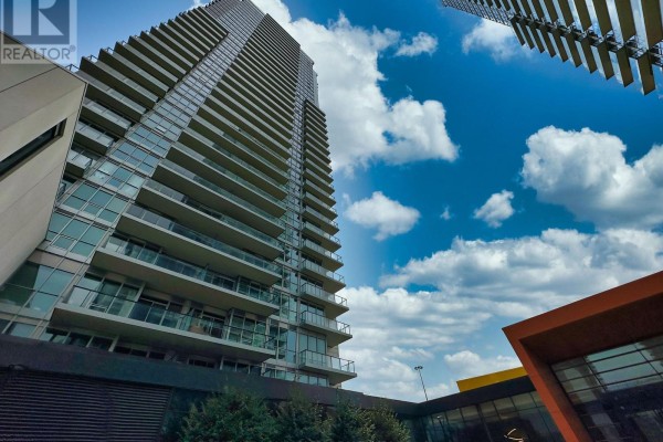 Apartment tower viewed from below, showing balconies and windows. - 801 - 95 Mcmahon Drive, Toronto
