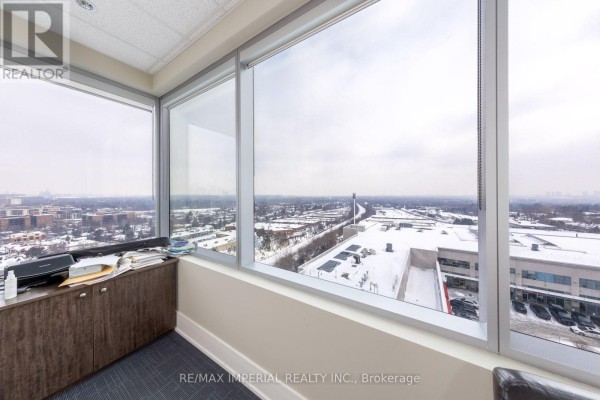 Office interior with large windows overlooking a snowy cityscape and buildings - 803 - 7191 Yonge Street, Markham