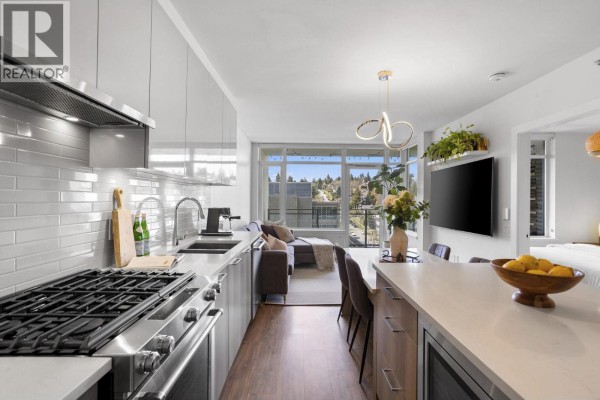 Kitchen layout showing dining area, large windows, and contemporary lighting fixtures - 803 258 Nelson's Court, New Westminster