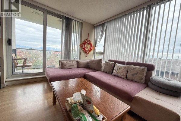 Living room featuring a purple sectional couch, coffee table, and a large window with a view. - 803 5068 Kwantlen Street, Richmond