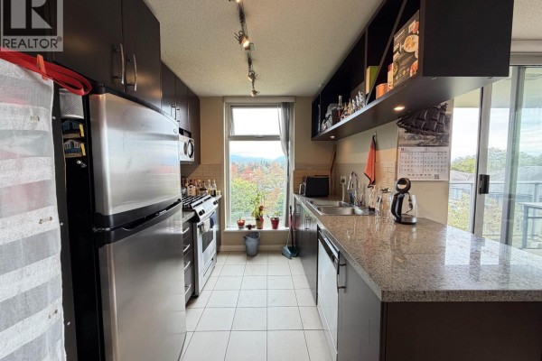 Kitchen with stainless steel appliances, granite countertops, dark cabinets, and a window overlooking trees. - 803 5068 Kwantlen Street, Richmond