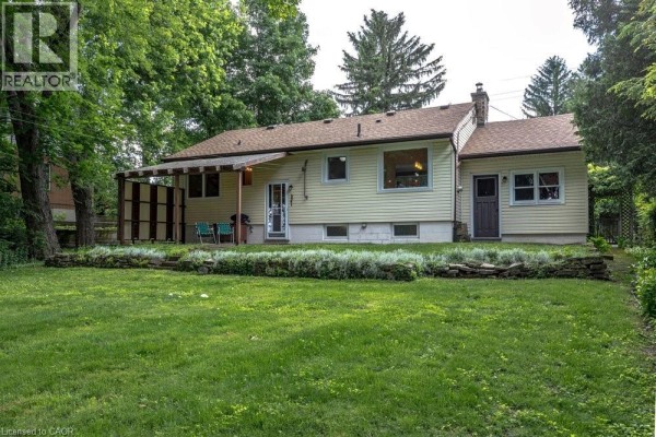 Another angle of the house showing the side entrance and surrounding greenery. - 803 Montgomery Drive, Ancaster