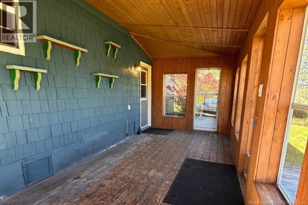 Wood-floored hallway with patterned wallpaper, dark wainscoting, and interior doors. - 8034 Route 134, Galloway