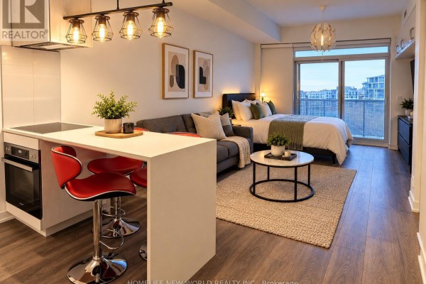 Studio apartment with an open-plan living area featuring a kitchen island, sofa, bed, and balcony view. - 804 - 20 Richardson Street, Toronto