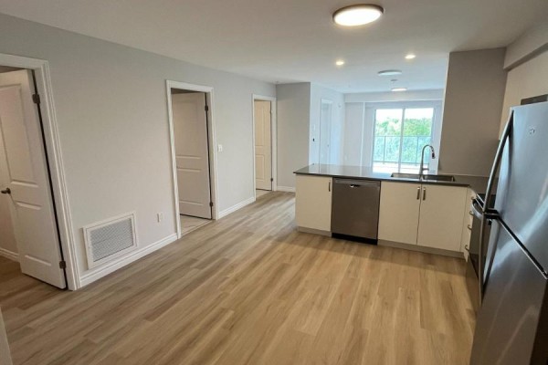 View of living area and hallway leading to bedrooms and bathroom in apartment. - 804 - 425 Watson Parkway N, Guelph