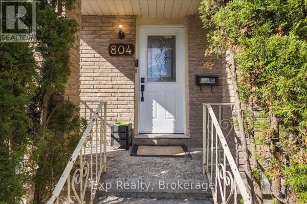 Close-up of the front entrance with a white door, address number 804, and stone facade. - 804 Sherbrooke Street, Peterborough