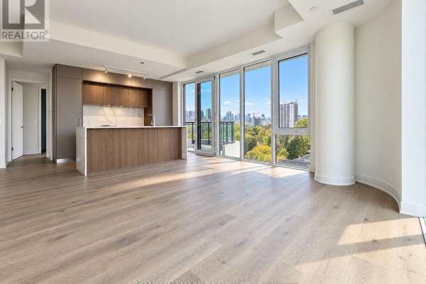 Spacious open concept living area with light wood floors and large windows. - 805 - 322 Dupont Street, Toronto