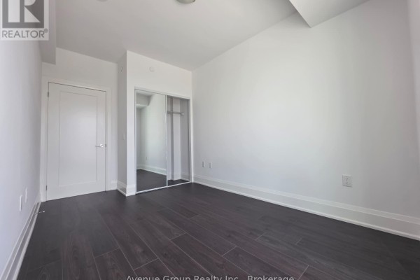 Another view of the bedroom showing doors and mirrored closet. - 805 - 700 Sheppard Avenue W, Toronto