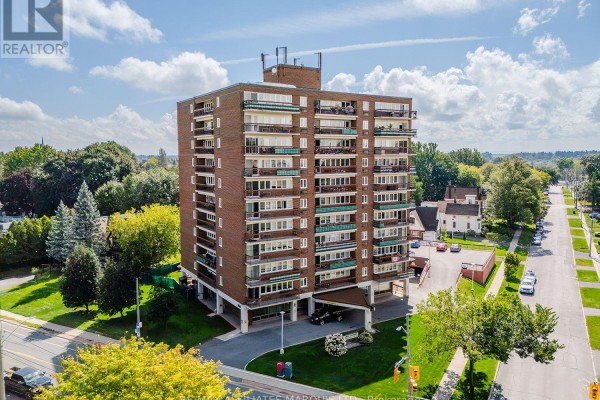 Elevated view of the tall brick apartment building, showing its facade and surroundings. - 806 - 308 Second Street E, Cornwall