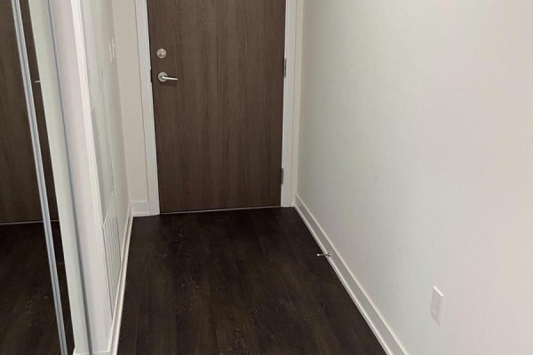 Entryway with mirrored closet and dark wood flooring - 806w - 27 Bathurst Street, Toronto