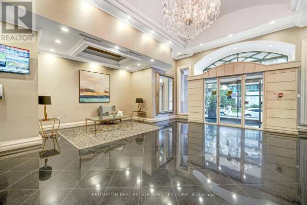 A hotel-like lobby with a chandelier, seating area, and polished dark floors. - 807 - 7 Lorraine Drive, Toronto