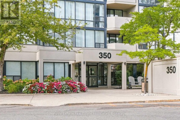 Entrance to the apartment building at 350 Rathburn Road West with landscaping. - 808 - 350 Rathburn Road W, Mississauga