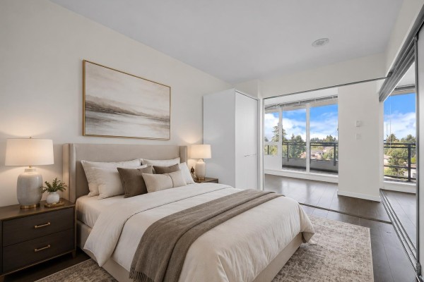 Curved balcony with glass railing overlooking trees, buildings, and distant mountains. - 808 13303 Central Avenue, Surrey