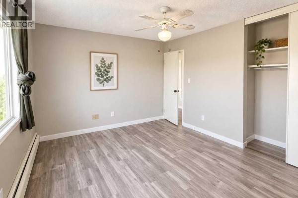 Aerial view showing the apartment buildings, swimming pool, parking areas, and suburban setting. - 809, 8948 Elbow Drive Sw, Calgary