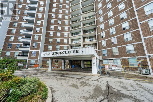 Close-up of the apartment building entrance with a sign reading "10 Edgecliffe" and surrounding construction. - 809 - 10 Edgecliffe Golfway, Toronto