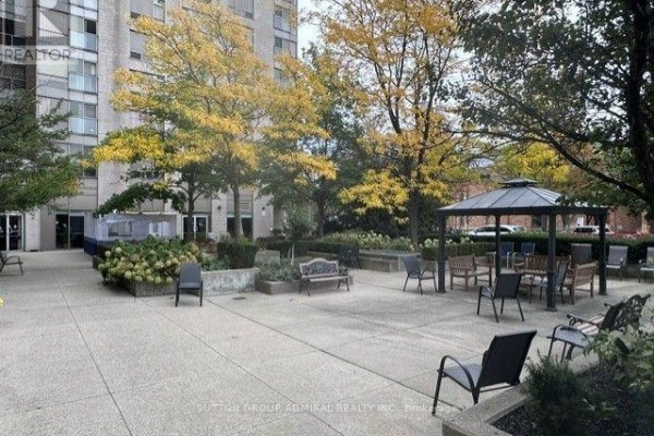 Outdoor patio area with tables, chairs, and a gazebo. - 809 - 2 Neptune Drive, Toronto