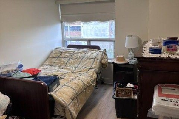 Bedroom with a bed, nightstand, dresser, and window. - 809 - 2 Neptune Drive, Toronto