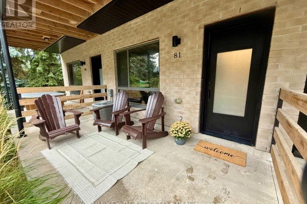 Front entrance patio with three Adirondack chairs, rug, and potted plant. - 81 - 369 Essa Road, Barrie
