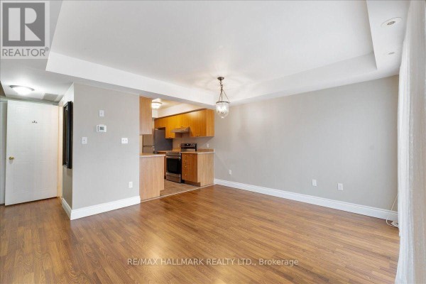 Living and dining area with hardwood floors and a glimpse of the kitchen. - 81 - 4620 Guildwood Way, Mississauga
