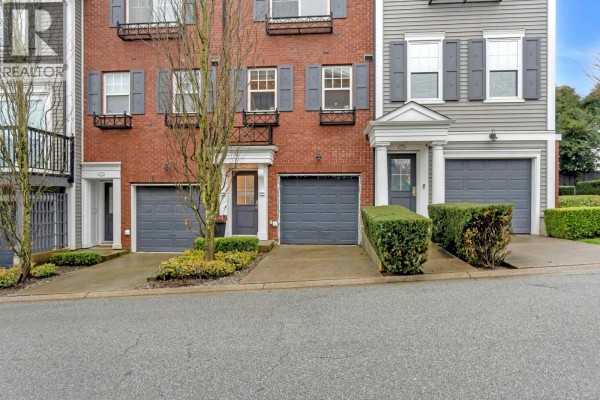Close-up of townhouse entrance with garage and decorative shrubs - 81 688 Edgar Avenue, Coquitlam