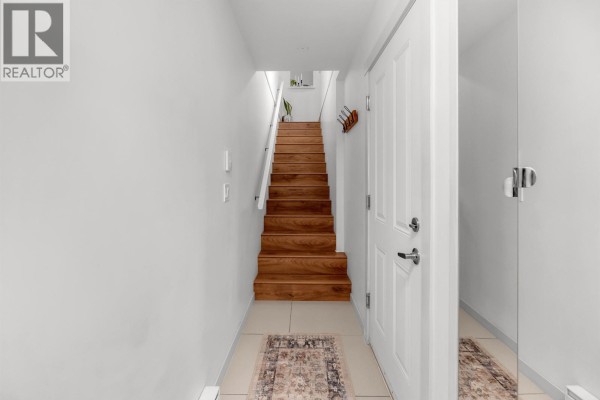 Entryway featuring wooden staircase and tiled floor - 81 688 Edgar Avenue, Coquitlam