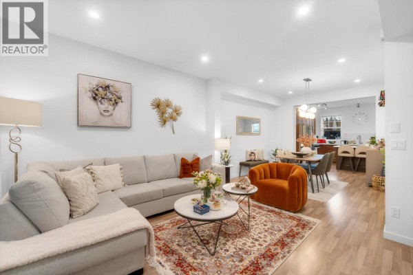 Living room with large windows, fireplace, and sectional sofa - 81 688 Edgar Avenue, Coquitlam