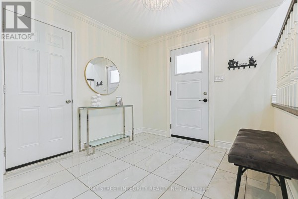 Entranceway with white doors, a circular mirror, a glass console table, and a dark bench. - 81 Dawn Hill Trail, Markham